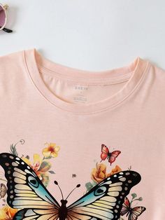 Experience elegance and grace with our Fluttering Beauty Butterfly Printed T-shirt. Made for women who embrace their femininity, this shirt features a stunning butterfly design that adds a touch of whimsy to any outfit. Crafted with high-quality materials, it's not just stylish but also comfortable to wear. Indulge in the beauty of nature with this must-have t-shirt. Color : Pink Style : Casual Pattern Type : Floral Pattern Type : Butterfly Pattern Type : Animal Neckline : Round Neck Sleeve Length : Short Sleeve Sleeve Type : Regular Sleeve Length : Regular Fit Type : Regular Fit Fabric : Slight Stretch Material : Fabric Composition : 100% Polyester Care Instructions : Machine wash or professional dry clean Sheer : No Size US Bust Cuff Length Shoulder Sleeve Length XS 2 86 32 61 38 15 S 4 Casual T-shirt With Butterfly Print, Spring Butterfly Graphic Print Top, Spring Graphic Tee With Butterfly Print, Summer Crew Neck Tops With Butterfly Embroidery, Spring Butterfly Embroidered Crew Neck T-shirt, Spring Crew Neck Top With Butterfly Print, Spring Crew Neck T-shirt With Butterfly Embroidery, Casual Pink T-shirt With Butterfly Print, Pink Short Sleeve T-shirt With Butterfly Print