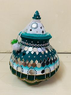 a green and white vase sitting on top of a table