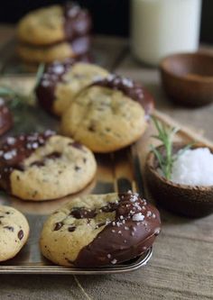 chocolate chip cookies with sea salt and sprinkles are on a tray next to a glass of milk