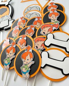 the cupcake toppers are made to look like cartoon characters and have orange hair