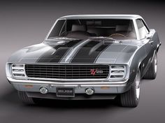 the front end of a muscle car with stripes on it's hood and hood scoops