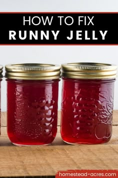 three jars filled with red liquid sitting on top of a wooden table