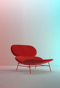 a red chair sitting on top of a white floor next to a blue and pink wall