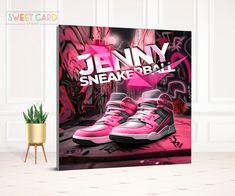 a pink sneaker poster on a wall next to a potted plant in an empty room