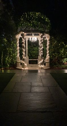 a gazebo covered in christmas lights at night