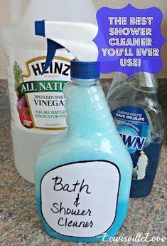 a bottle of bath and shower cleaner sitting on top of a counter next to other cleaning products