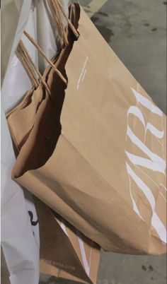 a brown paper bag sitting on top of white bags