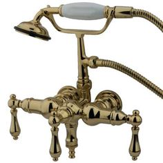 an antique style faucet with two handset and shower head in polished brass