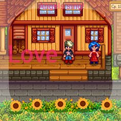 two people standing in front of a house with the word love on it and sunflowers