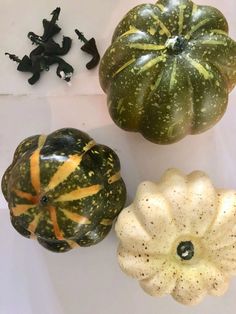 three decorative pumpkins sitting next to each other