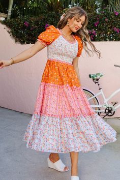 The patchwork dress of your DREAMS now available in bright and bold colors! The Emily Dress features the most fashion forward design, consisting of orange, pink, and stunning floral fabric. She also has an Ivy Favorite smocked bodice, tiered skirt, and dainty puff sleeves. This dress screams, "Ready for Summer" and will be your go-to dress for all your upcoming adventures! Cute Womens Dresses, Cute Long Dresses For Summer, Pioneer Dresses For Women, Fun Modest Outfits, Bright Color Clothes Style, Woman’s Dresses, Summer Dresses For Church, Preppy Winter Dresses, Cute Church Dress