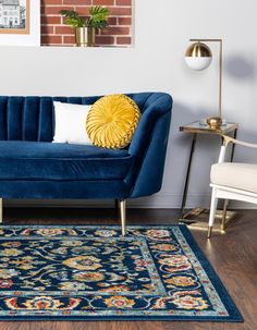 a living room with a blue couch and rug