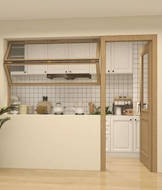 a kitchen with white cabinets and wooden floors