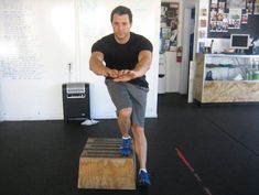 a man is doing exercises on a wooden box