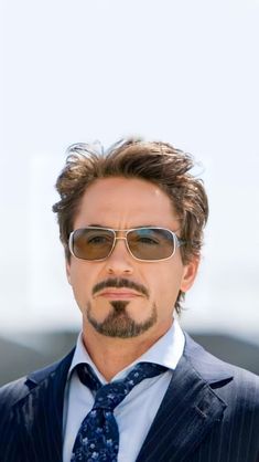 a man in a suit and tie wearing sunglasses