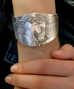 Friesian Horse head Stallion cuff bracelet is handmade in mirror polished pewter. Squeeze to fit 5 1/2 to 8 inches around wrists and is 2 inches at the widest point tapering to 3/4 inch either side. Handmade by the artist. USA Etching Jewelry, Friesian Horse, Horse Jewelry, High Relief, Leather Cuffs Bracelet, Horse Head, Silver Cuff Bracelet