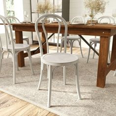 a dining room table with chairs around it