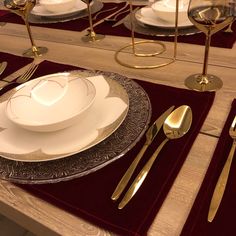 a table set with silverware and place settings