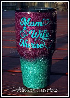 a purple and green glitter tumbler with the words mom's wife on it