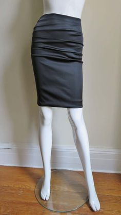 For Sale on 1stDibs - A gorgeous black stretch silk skirt from Dolce & Gabbana. It is a pencil style skirt with horizontal ruching across the front and back. There is functional Elastane Pencil Skirt For Party, Elegant Ruched Pencil Skirt For Party, Elegant Ruched Skirt For Formal Occasions, Fitted Ruched Bottoms For Workwear, Elegant Ruched Mini Skirt, Elegant Fitted Mini Draped Skirt, Elegant Fitted Gathered Mini Skirt, Elegant Fitted Pencil Skirt With Gathered Detail, Elegant Gathered Mini Skirt