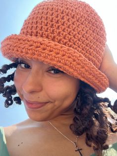 a woman wearing an orange crochet hat