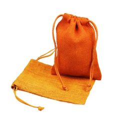 an orange bag sitting on top of a yellow cloth mat next to a white background