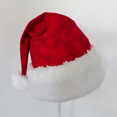 "This festive Santa hat is made up in a cozy red flannel tie dye cotton fabric. Great novelty party hat. Hat is made in the traditional cone style stocking cap for Santa. Red tie dye flannel is accented with a white faux Sherpa fur fabric trim. Proportions of the hat are generous and will fit most head sizes, ladies or gents. Hat is a soft slouch cone style. Great Santa hat for that hippie at heart. Measurement for opening for your head is 25\" circumference and the length is 18\". There is a sn