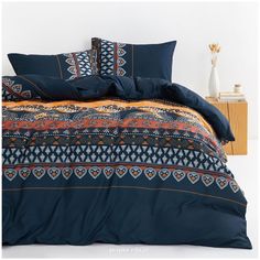 a bed covered in blue and orange comforters