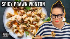 a woman holding chopsticks in front of a plate of food with the words spicy prawn wonton on it