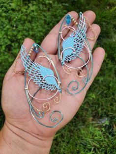 Wings Ice Blue, Gold and Light Pink You will receive a right and a left with this order. This is made to order in 3 to 5 business days of purchase. Elf ear cuffs are lightweight, stylish and one size fits all. You'll find a pair that is suitable for any event be at the Renaissance Fair, a fairy festival, or just a fun night out on the town! All Elf Ear Cuffs are made with artistic wire, silver plated non-tarnish copper, Nickel free. All Cuffs come as a set and easily fit any size ear by gently a Handmade Blue Jewelry For Cosplay, Blue Handmade Jewelry For Cosplay, Handmade Fantasy Wrap Earrings As A Gift, Handmade Whimsical Jewelry For Cosplay, Whimsical Handmade Jewelry For Cosplay, Handmade Elven Earrings For Gift, Diy Fairy Wings, Elf Ear, Elf Ear Cuff