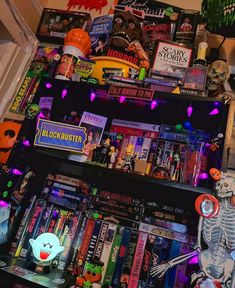 a book shelf filled with lots of books and halloween decorations on top of each shelf