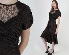 "Vintage 70s disco cocktail dance party midi dress. Ruched wiggle fit with hi-lo mermaid hem skirt. Sheer floral lace chest and open back. Shiny black poly jersey material. Dress zips up the back. size estimate: S/M shoulders: draped bust: 34\" waist: 26\" hips: 36\" total length: 39\" - 48\" Model is 5'9\" and measures 36\" bust, 25\" waist, 34\" hips. Belts/accessories are not included unless noted in the description. * Visit the shop * https://www.etsy.com/shop/americanarchive" Fitted Ruched Midi Dress For Evening, Fitted Midi Dress For Spring Costume Party, Stretch Disco Dresses For Evening, Fitted Knee-length Dresses For Costume Party, Retro Fitted Knee-length Midi Dress, Flirty Fitted Midi Dress For Evening, Fitted Midi Dress For Evening And Party Season, Retro Knee-length Party Dress, Vintage Midi Dress With Fitted Bodice For Party