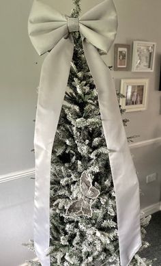 a white christmas tree with a large bow