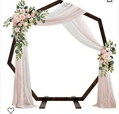 a wedding arch decorated with flowers and greenery