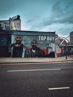 a large mural on the side of a building with two black men's faces