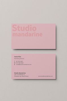 two pink business cards with the words studio mandarinne written on each one in white