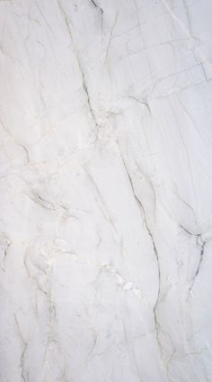 a white marble textured surface with black and grey lines on the top right side