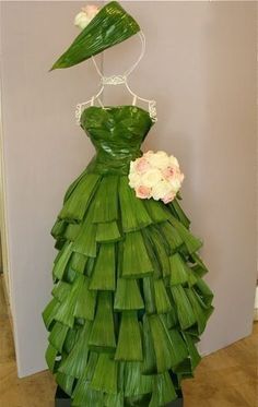 a green dress made out of leaves and flowers