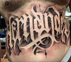 a man's chest with the word tattoo on it and his name written in cursive letters