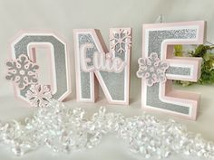 the letters are decorated with snowflakes and glitters for a festive display