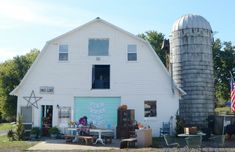 a white barn with an american flag on it