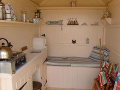 a small kitchen with white walls and cabinets