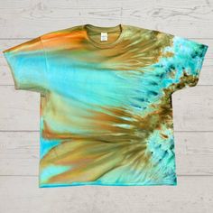 a t - shirt with an image of a blue and orange tie dye design on it