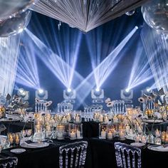 an image of a party setting with lights and decorations on the tables in front of them