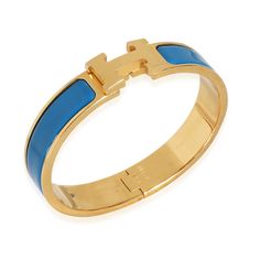 This is part of Chairish’s Costume Jewelry assortment.  Hermes Clic H Blue Bracelet in Gold Plated   PRIMARY DETAILS   SKU: 139650   Listing Title: Hermes Clic H Blue Bracelet in Gold Plated   Condition Description: Introduced in 2000, the Clic H bracelet from Hermes is made in France and characterized by the 'H' logo and enamel detailing. The accessory is named after the bangle's clasp-style closure.       Retails for 700 USD. In excellent condition. 6.25 in in length.   Brand: Hermes   Collection/Series: Clic H   Metal Type: Gold Plated   Chain or Bracelet Length (in): 6.25   Pre-Owned Jewelry Condition: Excellent   SIDE STONE INFORMATION   Original Box?: No   Original Papers?: No   This item has been used and may have some minor flaws. Before purchasing, please refer to the images for t Cartier Bangle, Modern Bangle, 18k Gold Bangle, H Bracelet, Contemporary Bracelets, Hermes Jewelry, Jewelry Lookbook, Gold Plated Bracelets, Vintage Cartier Bracelet