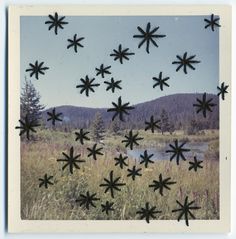 an image of snowflakes in the sky over a field with trees and water