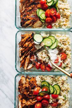 three glass containers filled with rice, cucumbers and chicken next to each other