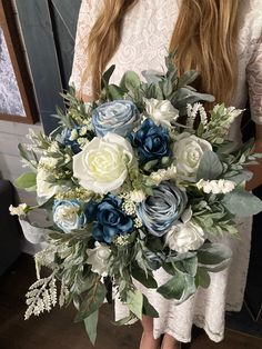 a woman holding a bouquet of flowers in her hands