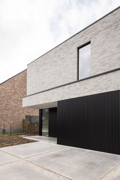 a modern house with black and white stripes on the outside, as well as large windows