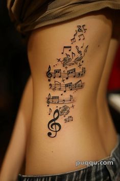 a woman's lower back with musical notes and trebles on her ribs